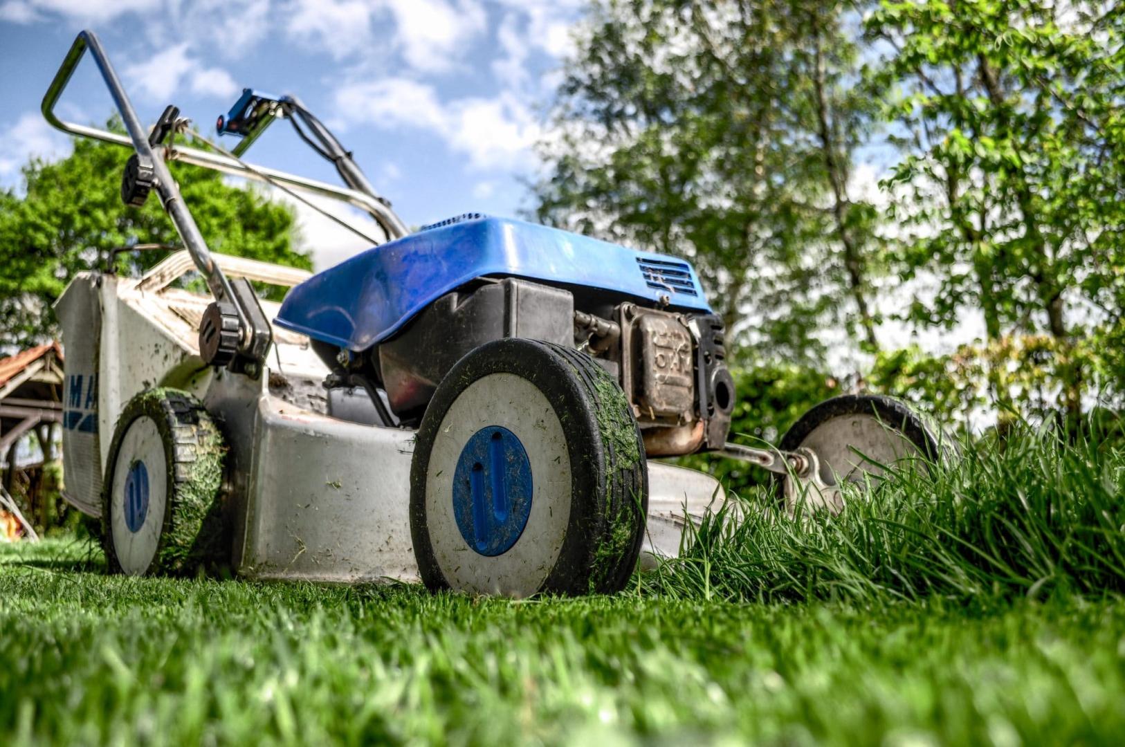 Lawn mower in green grass