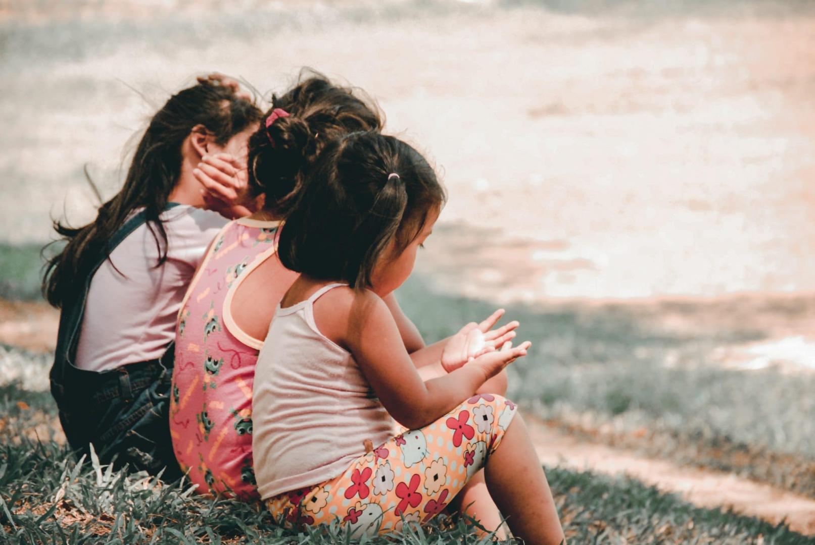 Children sitting on grass