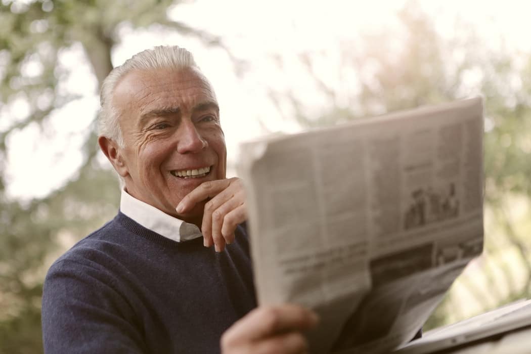 Man reading newspaper.