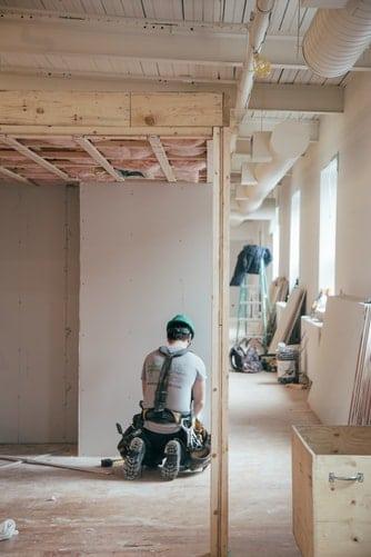 Construction worker man working on an incomplete building.