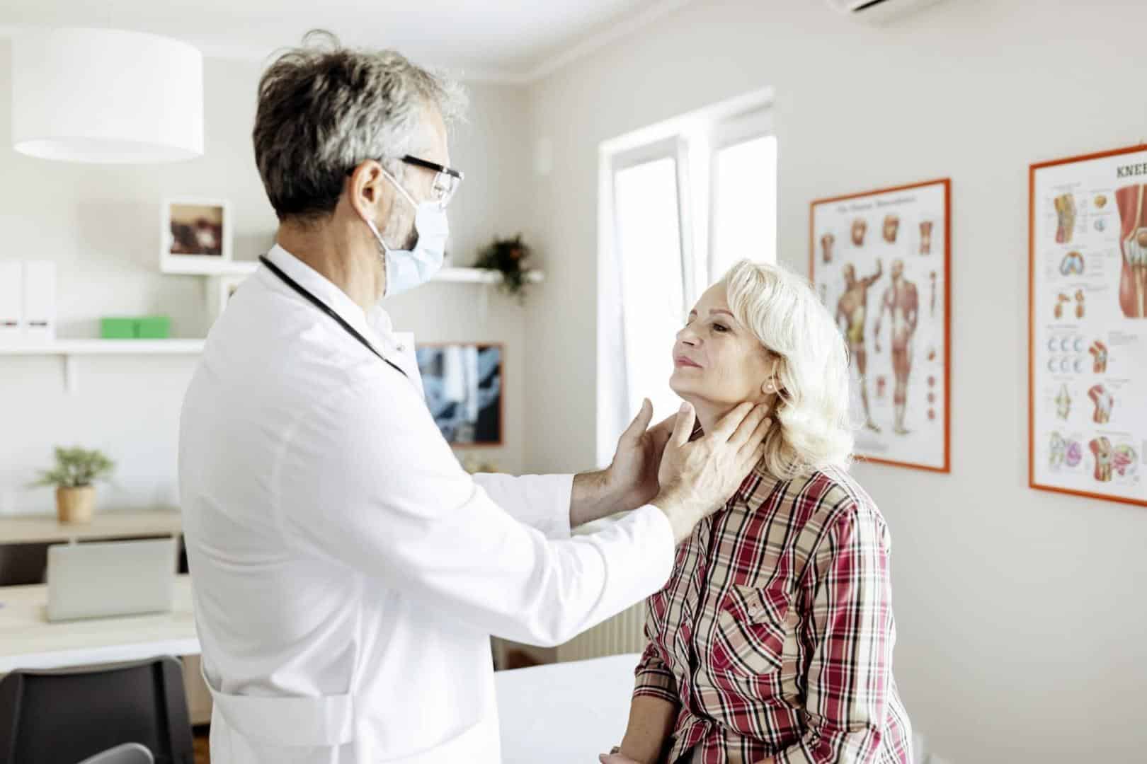 Doctor performing throat exam on patient.