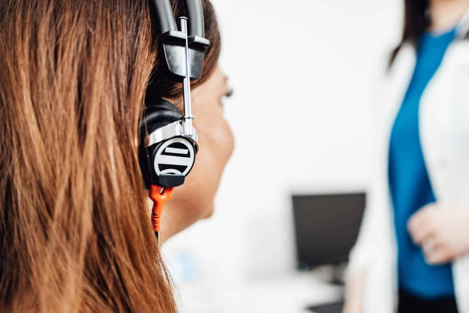 Woman with headphones getting a hearing test.