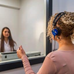 Woman gets a hearing test in an audiologist's office.