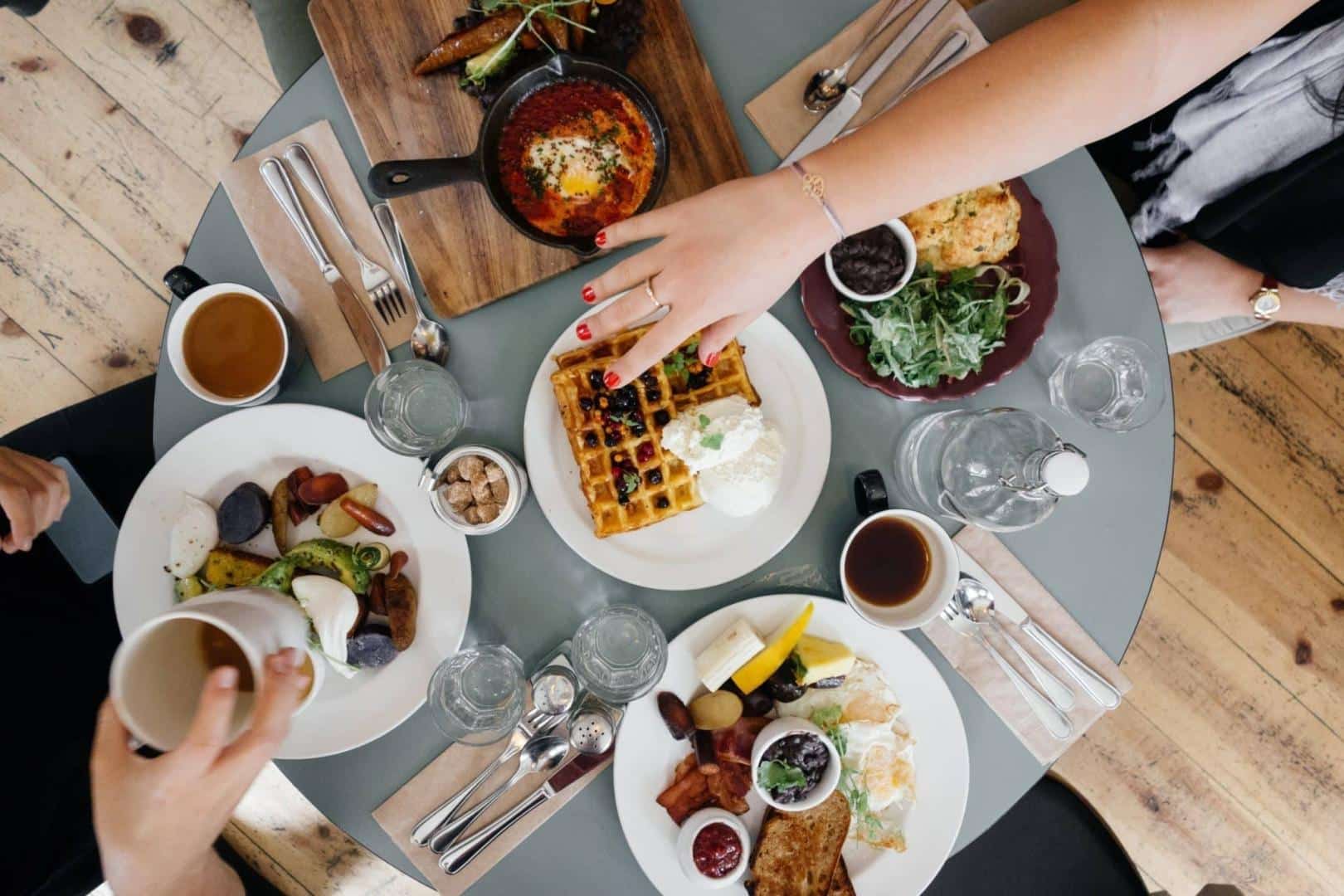 Shot of a round table with breakfast food at a restaurant.