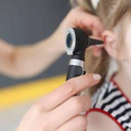 Little girl having an ear exam.