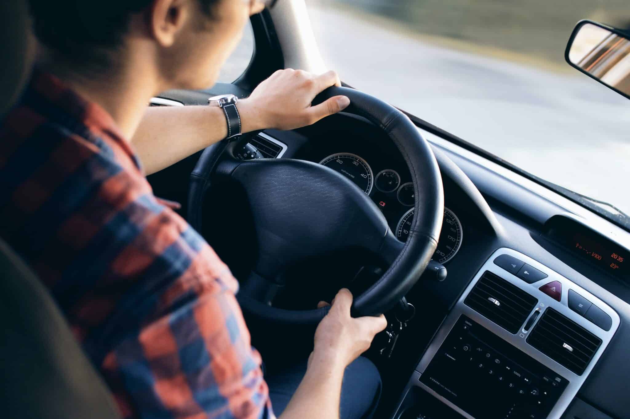 Close-up of a person driving a car.