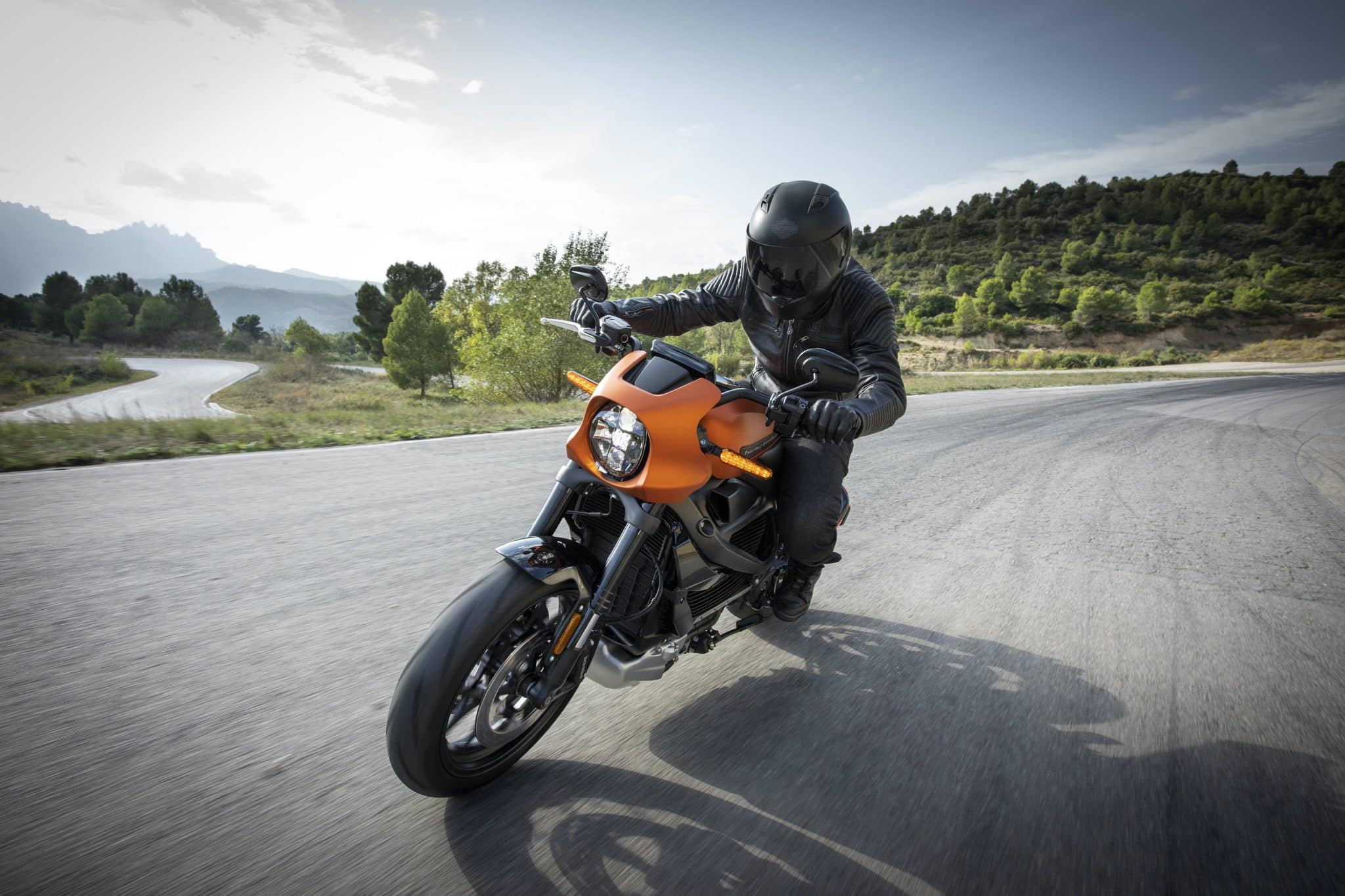 Man riding his motorcycle on an open road.