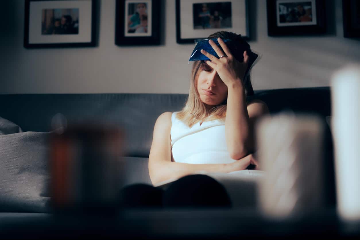 Woman icing her head after getting a concussion.