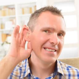 Man showing off his new hearing aid