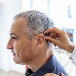 Man sees doctor about hearing aid