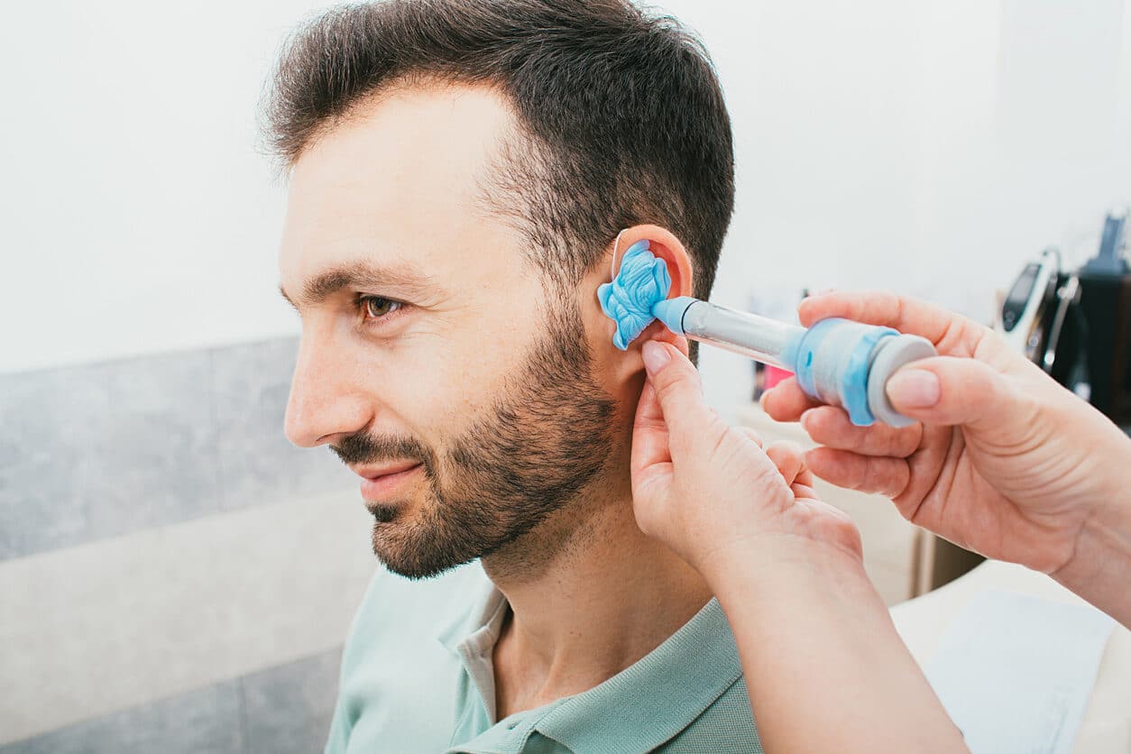 ENT specialist creating an ear mold for a patient.