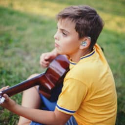 Young boy wears hearing aid
